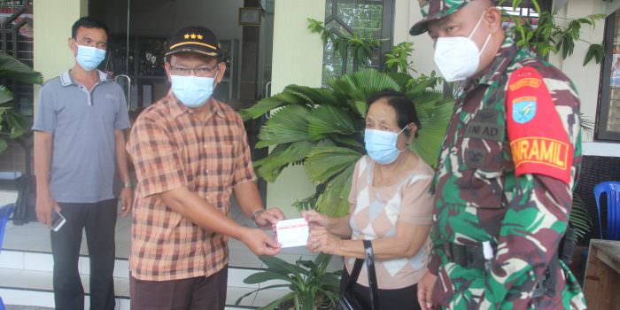 MENYERAHKAN: Camat Jekan Raya Sri Utomo (dua dari kiri) saat menyerahkan tanda kartu sudah mengikuti vaksin kepada salah seorang warga di Kantor Kecamatan Jekan Raya, Minggu (22/8). (foto: PATHUR/KALTENG POS)