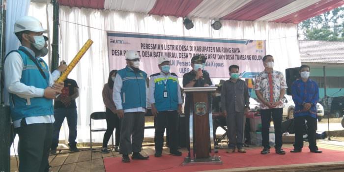 PERESMIAN: Wakil Bupati Mura, Rejikinoor (berdiri di podium) meresmikan aktifnya jaringan listrik di empat desa, Sabtu (31/07). (FOTO:DADANG/KALTENG POS)