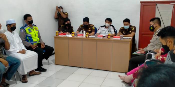 PERDAMAIAN: JPU bersama aparat kepolisian saat melakukan penghentian penuntutan atau istilah restorative justice terhadap seorang anak di bawah umur dalam kasus Lakalantas di kantor Kejaksaan setempat, Selasa (21/9). (FOTO: HER/KALTENG POS PROSES )