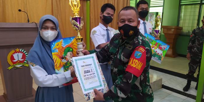 JUARA: Kasdim 1013/Muara Teweh Mayor Inf Mahsun Abadi Sag menyerahkan piala kepada juara satu lomba melukis tingkat SMA, Rabu (29/9). (FOTO: PENREM 102/Pjg)