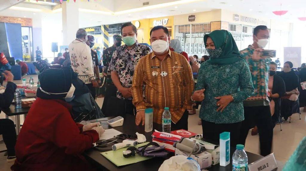 DAMPINGI: Plt Kepala Dinkes, Umar Kaderi (kiri) mendampingi Bupati Kotim, H Halikinnor melihat proses vaksinasi, belum lama ini. (FOTO: HUMAS UNTUK KALTENG POS)