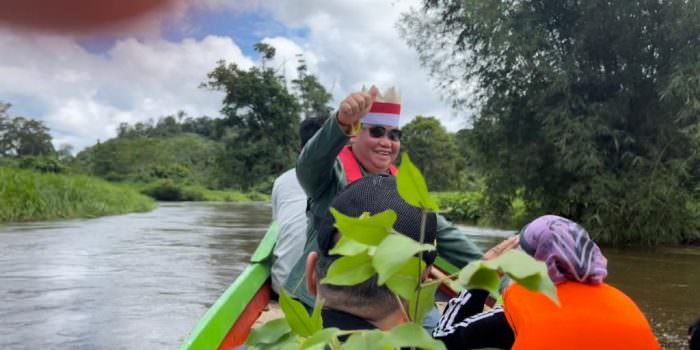 TRANSPORTASI: Bupati Kotawaringin Timur, H Halikinnor menaiki perahu kecil menyusuri sungai menuju ke Desa Tumbang Gagu, Kecamatan Antang Kalang, Rabu (10/11). (FOTO: IST UNTUK KALTENG POS)