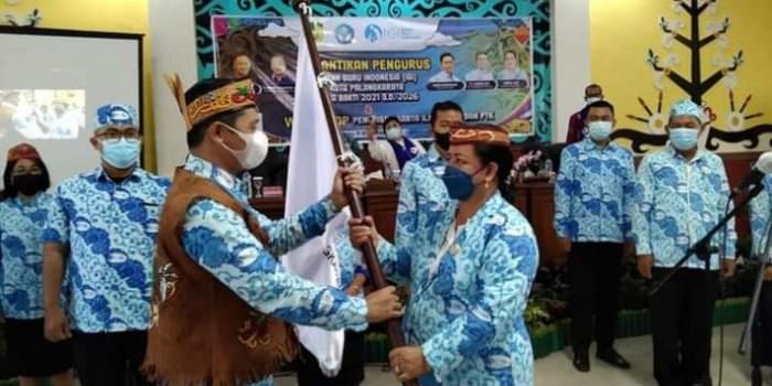 DILANTIK: Ketua Umum IGI Pusat, Danang Hidayatullah ketika menyerahkan bendera tanda dilantiknya Ketua IGI Kota Palangka Raya Hartani Netta, di Aula Peteng Karuhei II, belum lama ini. (FOTO: IGI PALANGKA RAYA UNTUK KALTENG POS )